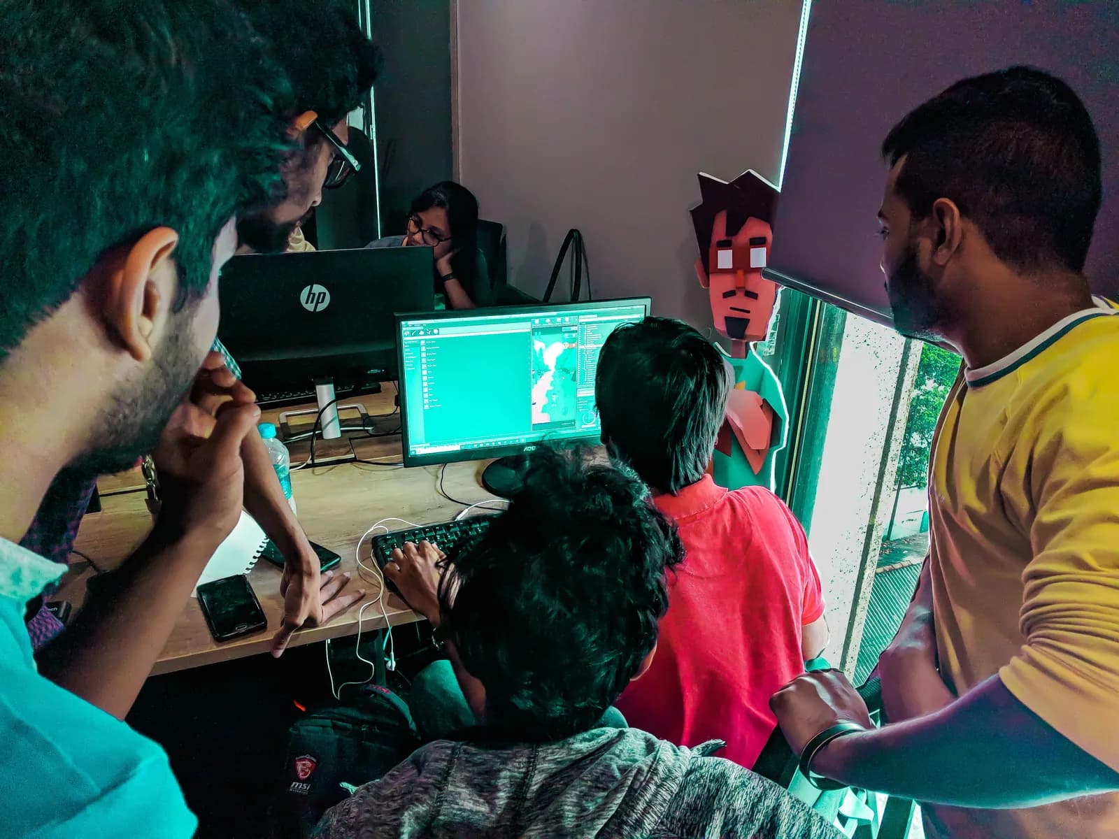 Artists collaborating around a computer