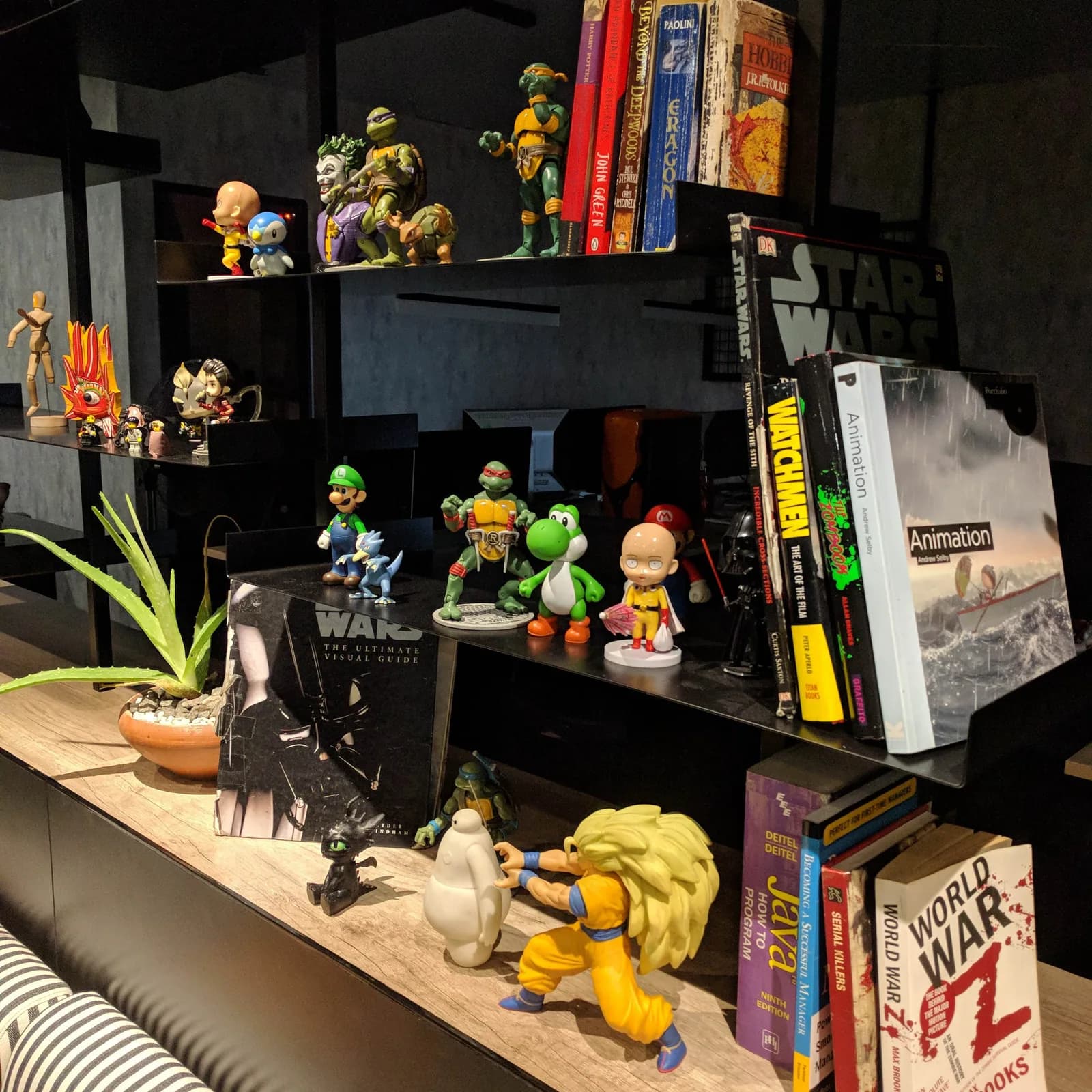 Books and character models on the studio shelves